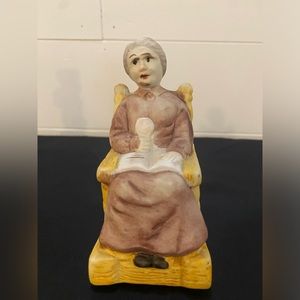 Vintage Figurine of Woman Sitting In Rocking Chair With Open Book Reading
